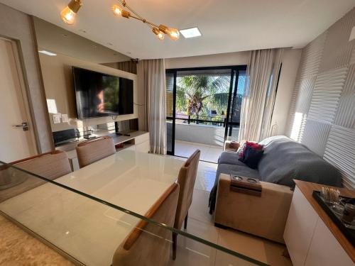a living room with a glass table and a couch at Happy Living Resort in Fortaleza