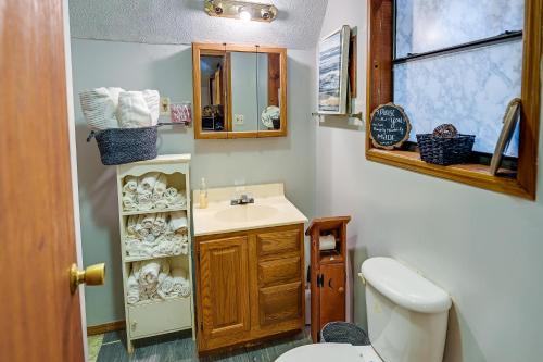 a bathroom with a sink and a toilet at Cozy Country Cabin 4 Mi to Cave Run Lake! in Wellington