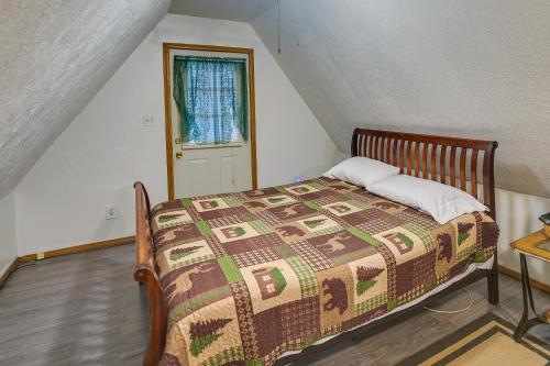 a bedroom with a bed with a quilt on it at Cozy Country Cabin 4 Mi to Cave Run Lake! in Wellington