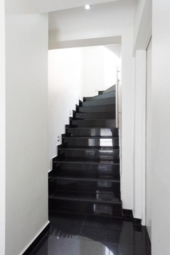 a staircase in a building with black steps at Bürgerhofhotel in Cologne