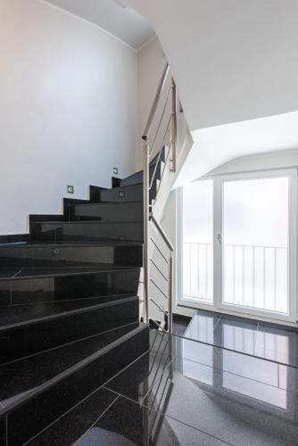 a staircase in a house with a window at Bürgerhofhotel in Cologne