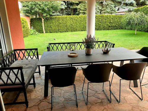 a table and chairs sitting on a patio at Seeliebe mit Sauna und nur 50 mtr. bis zum Strand in Senftenberg