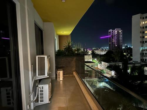 a balcony with a view of a city at night at Dakar Dreams Spinelle in Dakar