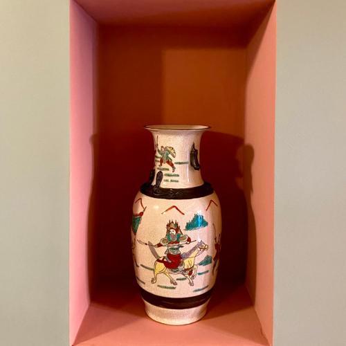 a vase is sitting in a pink box at N°30 CHARME Apartments in Vigevano
