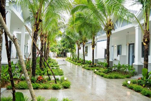 un patio con palmeras en un edificio en NatalieLe's Homestay, en Phu Quoc