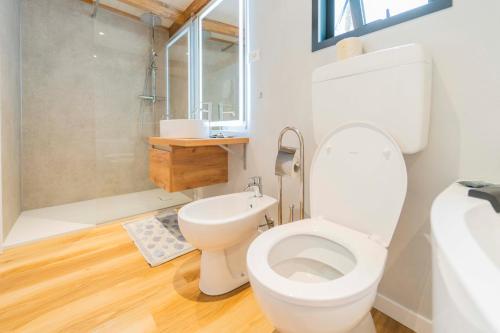 a bathroom with a white toilet and a shower at Villaggio Smeraldo in Moneglia