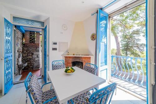 a dining room with a table and chairs and a fireplace at ToviMar Apartments in Taormina