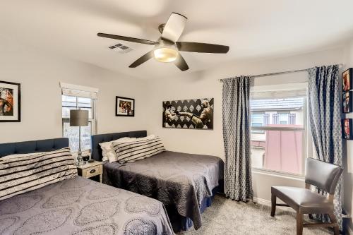 a bedroom with a bed and a ceiling fan at The Winner’s Retreat in Las Vegas