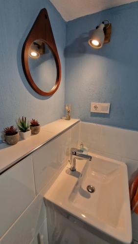 a bathroom with a sink and a mirror on the wall at Crissimo apartment in Panagia