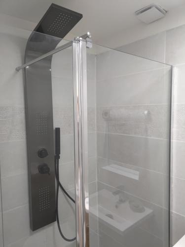 a shower with a glass door and a sink at Studio secteur pic Saint Loup in Combaillaux