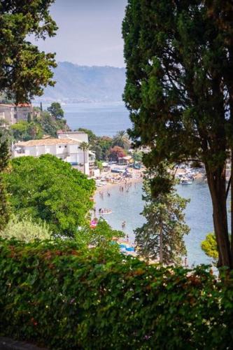 a view of a beach with people in the water at ToviMar Apartments in Taormina