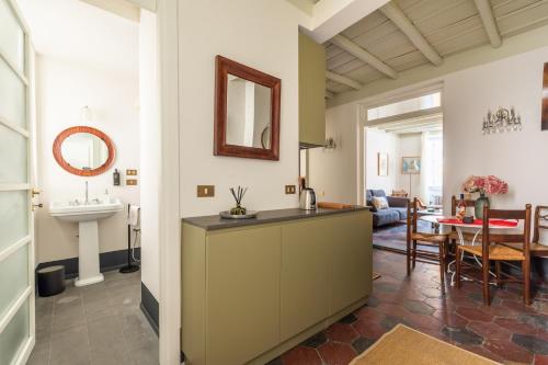 a kitchen and living room with a sink and a table at Charming Design Apartment in Monti in Rome