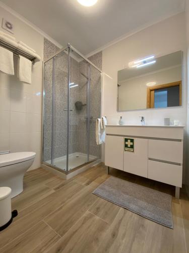 a bathroom with a shower and a sink and a toilet at Casa da Amoreira in Odeceixe