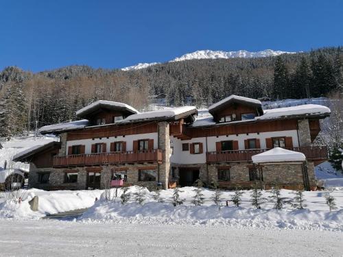 a large house with snow on the roof at Le Rêve in Courmayeur