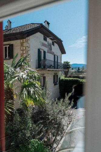 a building with a sign on the side of it at Angerburg Blumenhotel in Appiano sulla Strada del Vino