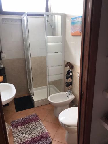 a bathroom with a shower and a toilet and a sink at Blu Village 2 (MT) in Marina di Pisticci