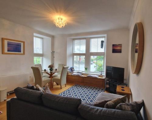 a living room with a couch and a table at Craigielea Apartment 3 in Lerwick