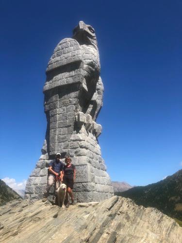 two people and a dog standing next to a statue at Giuditta FreeCarPark&Garden in Domodossola