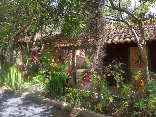 a house with a lot of flowers in front of it at Beco das Garrafas in Vale do Capao