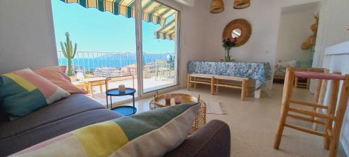 un salon avec un canapé et une grande fenêtre dans l'établissement Vue mer à couper le souffle - nouveau entièrement rénové, à Cannes