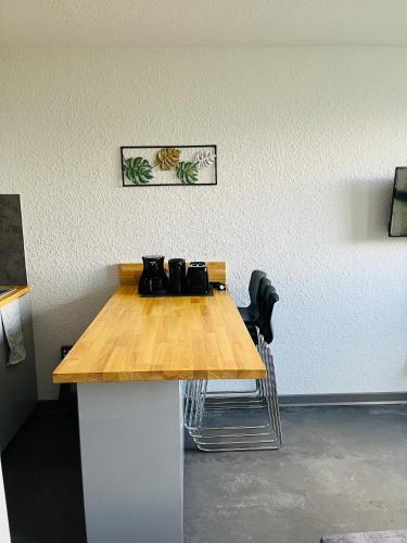 a wooden table in a room with two chairs at studio 4 pers praloup 1600 in Uvernet-Fours