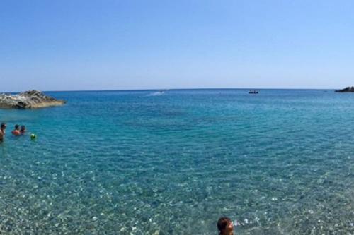 a group of people in the water at a beach at Baia di Copanello IMMINENS MARI in Copanello