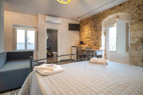 a bedroom with a bed with towels on it at Cuturissi Hospitality & Wellness in Ragusa