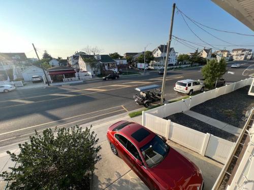 a red car parked on the side of a street at 1BR/BA Condo w/Patio - 8 min to Wildwood Beach/Boardwalk in Wildwood