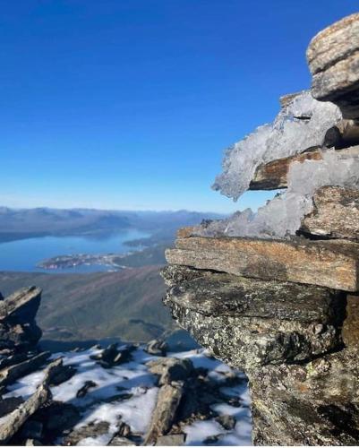a view from the top of a mountain with snow at Riverfront house with 98 inch TV, ps5 & activities in Narvik
