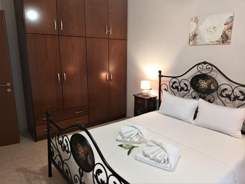 a bedroom with a black and white bed with wooden cabinets at ZENIA Pelion garden house in Platanidia