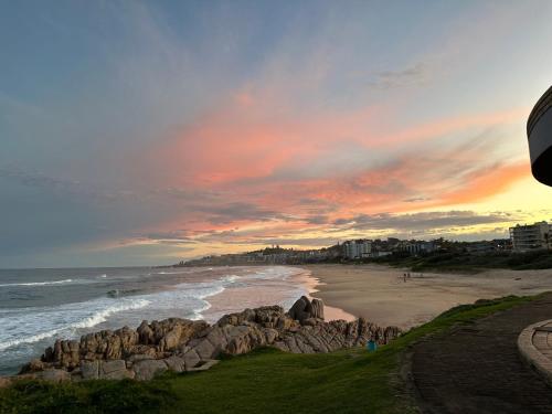 a beach with rocks and the ocean at sunset at Chamonix 16 in Margate