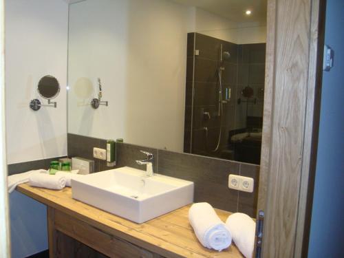 a bathroom with a white sink and a mirror at Franzlhof in Söll