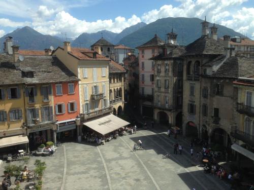 a group of buildings in a town with mountains at Giuditta FreeCarPark&Garden in Domodossola