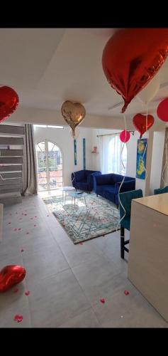 a living room with red balloons on the floor at Dolce Vita Palacio in Douala