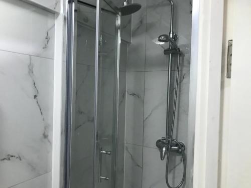 a shower with a glass door in a bathroom at Ensuite With Kitchen Ext Large Room With Balcony in Zone 2 in London