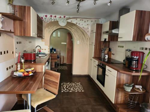 a kitchen with wooden counter tops and an archway at Naturparadies in Marktl