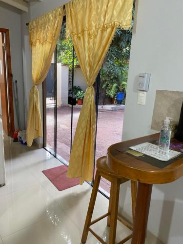 a room with a table and a window with curtains at POSADA DON CANDIDO in San Antonio