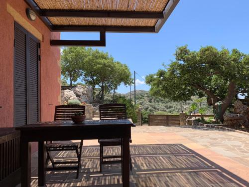 a patio with a table and two chairs on a patio at Archon Villa in Pandeleḯmon