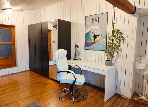 a office with a white desk and a chair at Seeyouin Karmelicka18 Apartment in Krakow