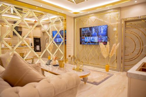 a living room with a white couch and a tv at Alexandras Palace in Bradford