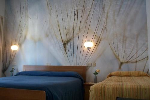 a bedroom with two beds and a wall with curtains at B&B da Guerrino in Farra dʼAlpago