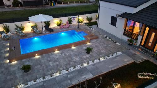 an overhead view of a swimming pool in a backyard at Palomino house in Sinj