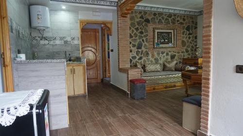 a kitchen and a living room with a couch at Blue House Town in Chefchaouene