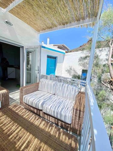 a porch with a couch on a patio at Casa del Mar Milos in Areti