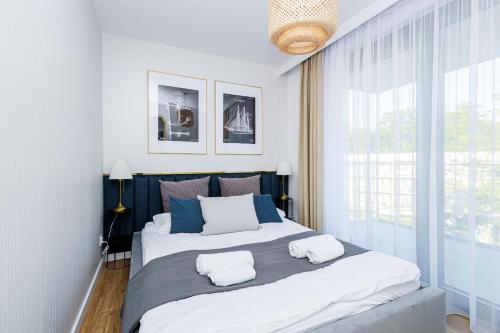 1 dormitorio con 1 cama grande y 2 almohadas en BALTIC RESORT REWAL 1 in Hevenia en Rewal