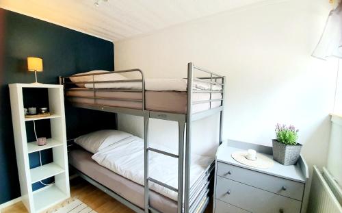 a bunk bed room with two bunk beds in it at Stationshuset Dalarna Apartments in Sörsjön