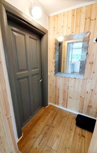 a room with a door and a mirror at Stationshuset Dalarna Apartments in Sörsjön