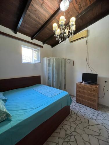 a bedroom with a bed and a chandelier at BlackStone.Shkodra in Shkodër