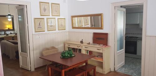 a living room with a table and a kitchen at Cortijo EL LLANO in Almería
