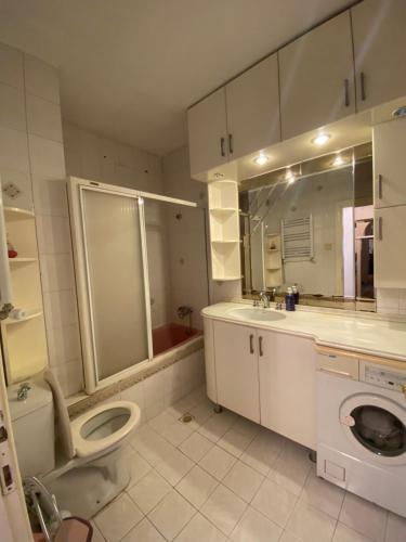 a bathroom with a toilet and a sink and a mirror at Kültür Suite meydan in Trabzon